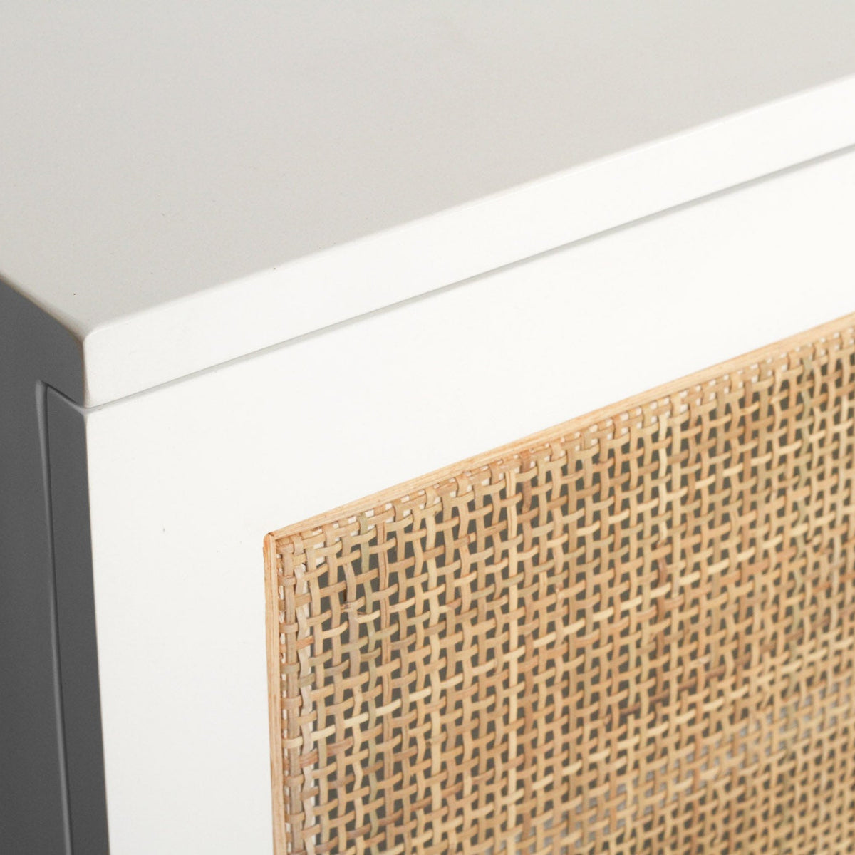 Beach House 300cm white and rattan entertainment unit, close-up of the satin white tabletop corner and natural rattan door