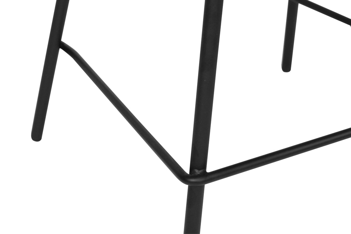 Close-up of the Bellevue counter stool’s black powder-coated steel legs and footrest