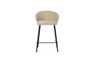 Bellevue Counter Stool with padded Pebble fabric seat and back, slim black powder-coated steel frame, modern elegant design. Front perspective.