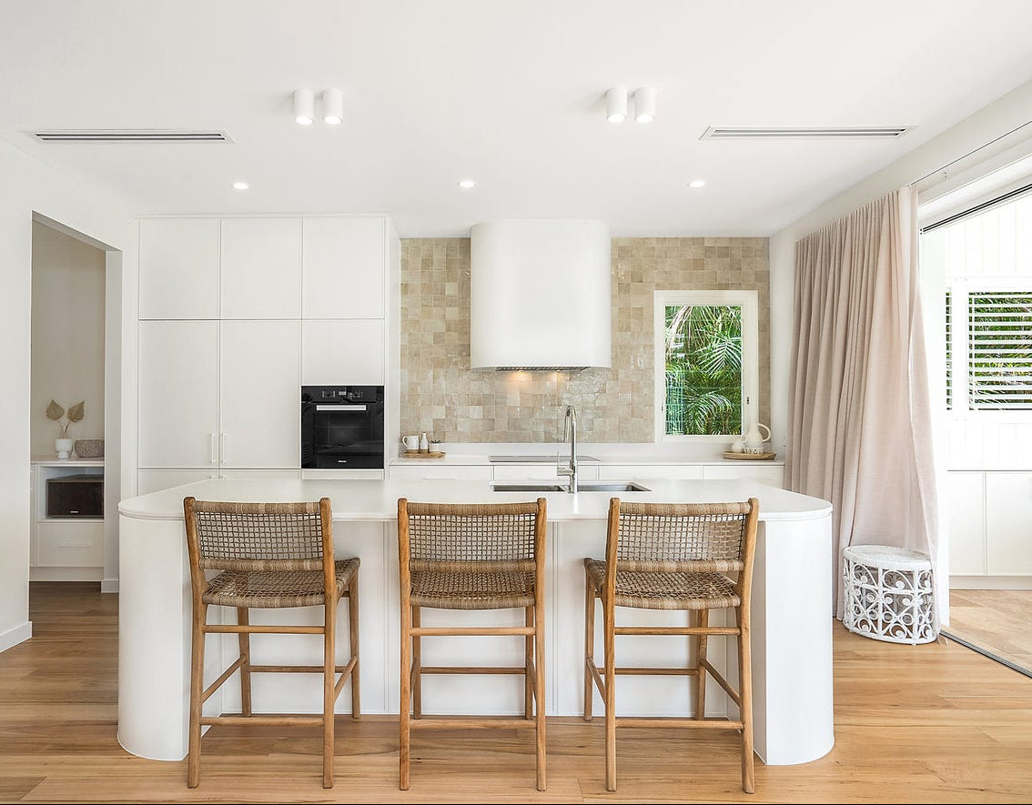 Bondi washed grey counter stools at a white kitchen island with timber flooring