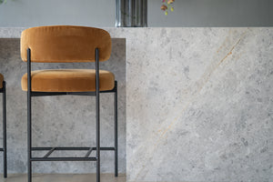 Fontaine Counter Stool with half-moon curved back and metal legs, upholstered in performance velvet in amber, modern Art Deco inspired counter stool for elegant interiors.  Modern kitchen counter stool.
