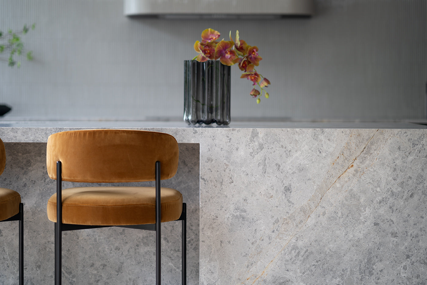 Fontaine Counter Stool with half-moon curved back and metal legs, upholstered in performance velvet in amber, modern Art Deco inspired counter stool for elegant interiors.  Modern kitchen counter stool.