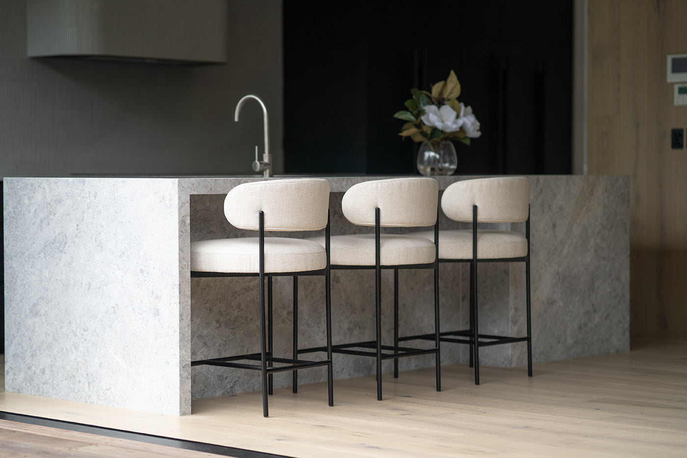 Fontaine Counter Stool with half-moon curved back and metal legs, upholstered in performance linen, modern Art Deco inspired counter stool for elegant interiors.  Modern kitchen living.