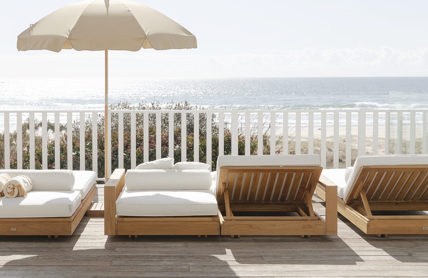 Rear view of the Harbour Island Double Outdoor Sun Lounger with Arms featuring a solid Grade A teak frame.