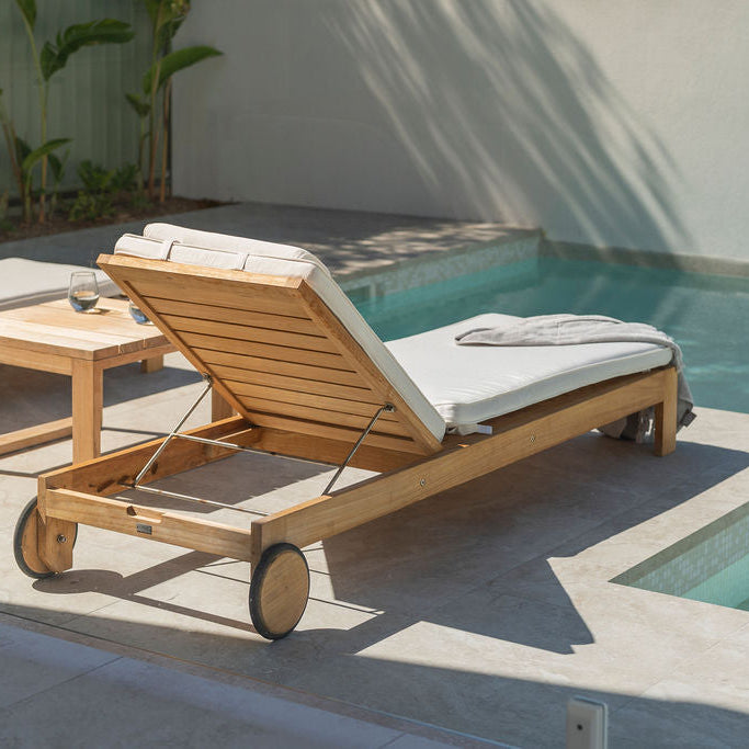 Harbour Island teak outdoor sun lounger beside a modern swimming pool