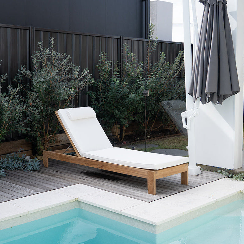 Harbour Island Slim Outdoor Sunlounger in Grade A teak with white Sunbrella cushion, adjustable backrest and wheels, coastal outdoor furniture for poolside or garden relaxation. Relax poolside.