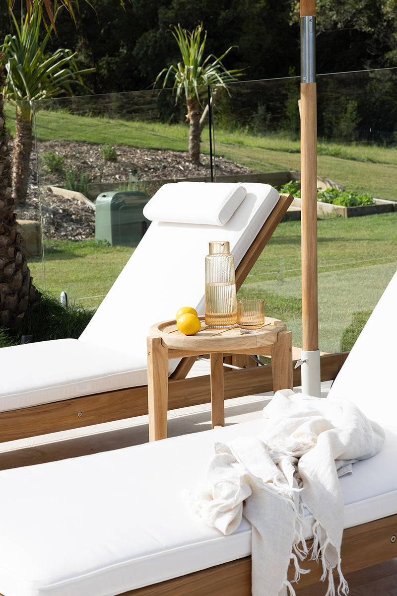 Harbour Island Slim Outdoor Sunlounger in Grade A teak with white Sunbrella cushion, adjustable backrest and wheels, coastal outdoor furniture for poolside or garden relaxation. Resort style living.