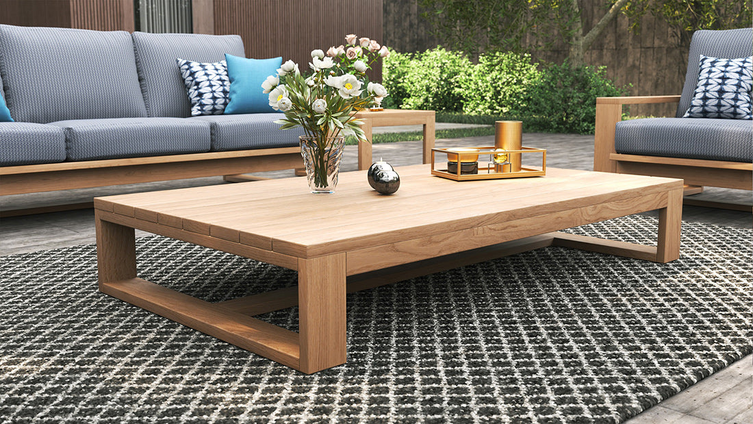 Harbour Island Outdoor Coffee Table – oversize low, made from sustainable premium-grade teak, showcasing a robust, minimalist design ideal for indoor or outdoor use with lasting durability. Styled in this beautiful outdoor setting.