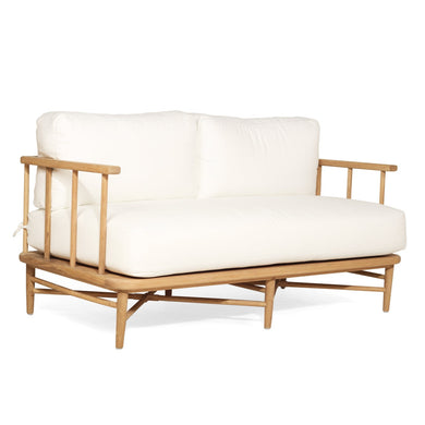 The Harbour Island Two Seater Sofa with light timber frame and white cushions – coastal luxe design perfect for relaxed interiors