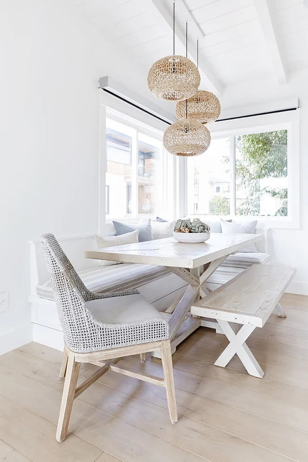 Lili Round Woven Pendant Light by Uniqwa Collections styled in a coastal dining room, showcasing natural woven banana fibre texture and organic pendant lighting design.