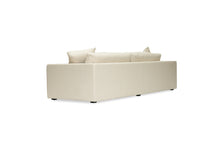 Load image into Gallery viewer, Lucca Four Seater Sofa in performance linen blend upholstery in Dune, refined design, available in boucle oatmeal or saddle leather.  Back angle perspective.