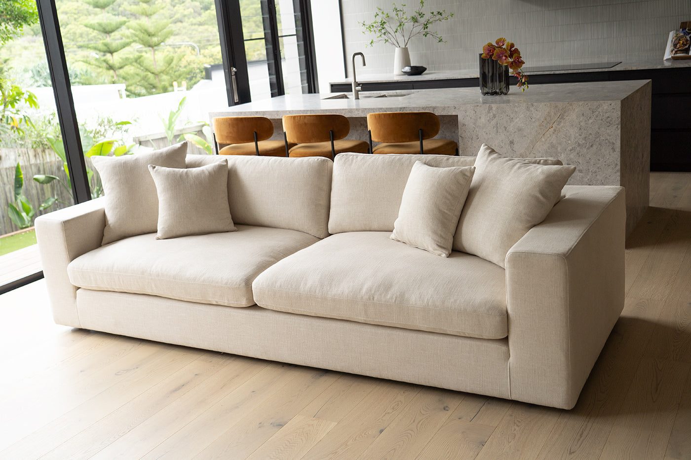 Lucca Four Seater Sofa in performance linen blend upholstery in Dune, refined design, available in boucle oatmeal or saddle leather. Styled beautifully in this luxury modern interior.
