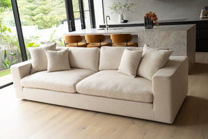 Lucca Four Seater Sofa in performance linen blend upholstery in Dune, refined design, available in boucle oatmeal or saddle leather. Styled beautifully in this luxury modern interior.