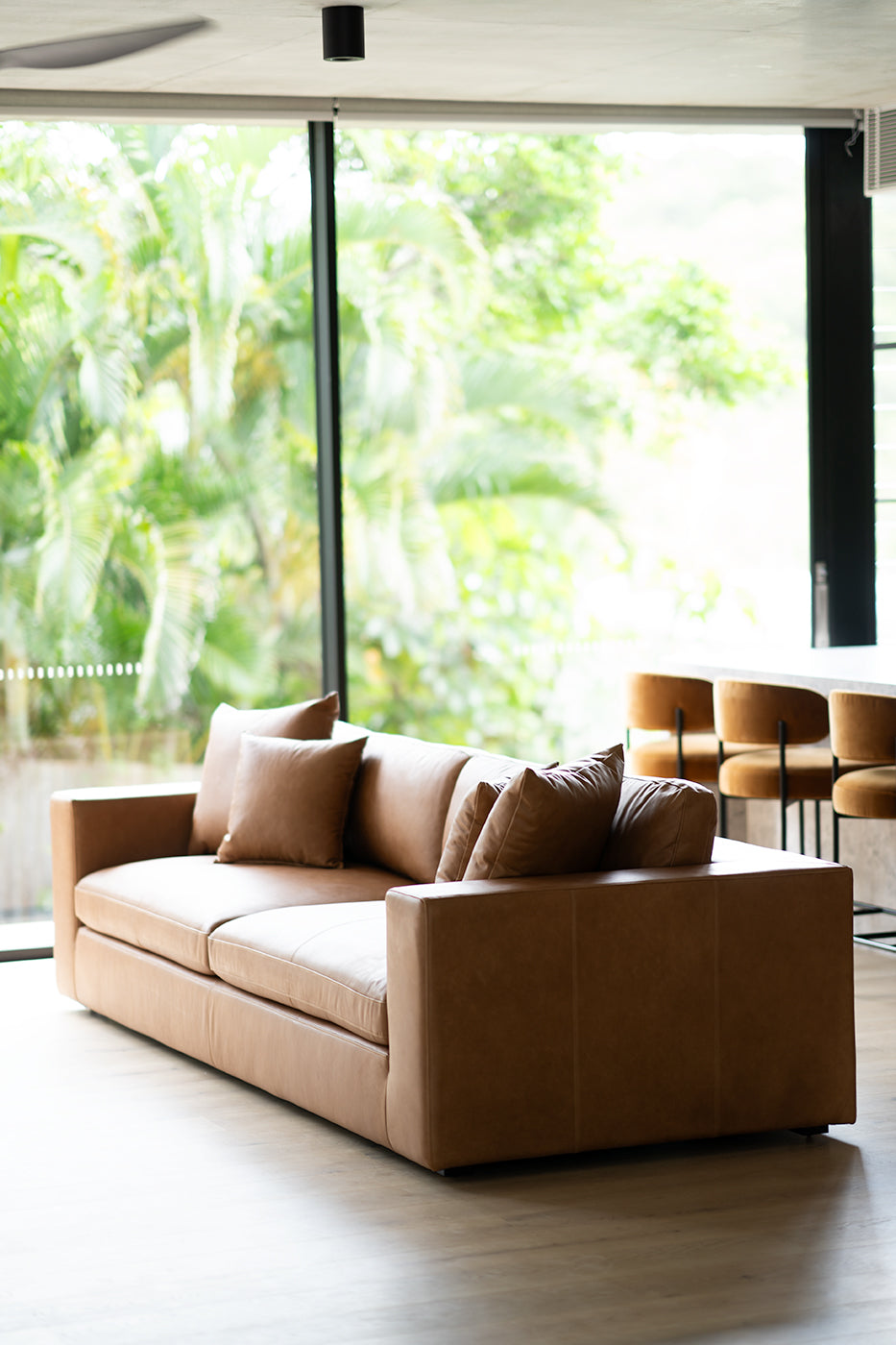 Lucca Four Seater Sofa in trend saddle tan leather with sleek, sophisticated design. Styled in this modern home.