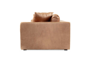 Lucca Four Seater Sofa in trend saddle tan leather with sleek, sophisticated design. Side perspective.