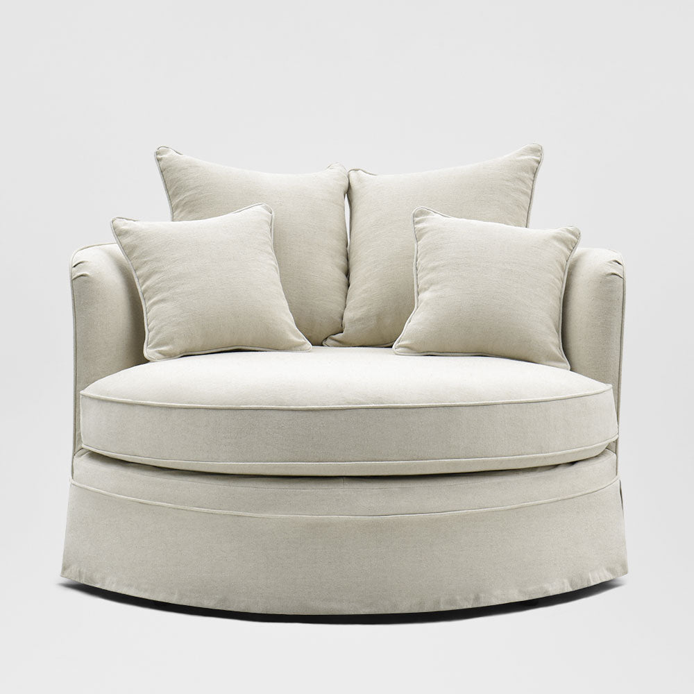 Noosa beige snuggle occasional chair with rounded seat, curved back and skirted base, front view