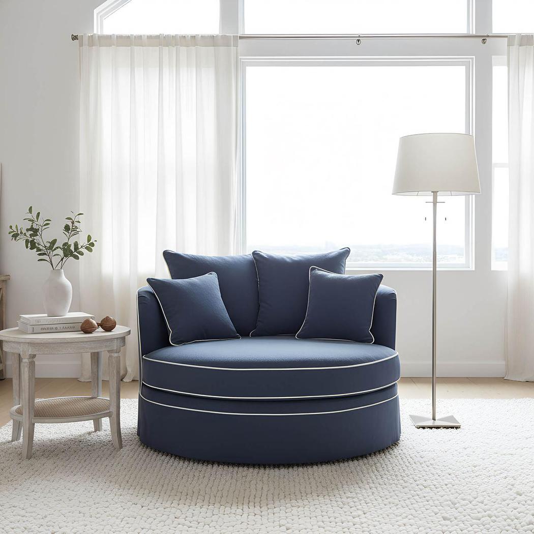 Noosa snuggle occasional chair in Navy with White Piping, styled beside a window with a side table
