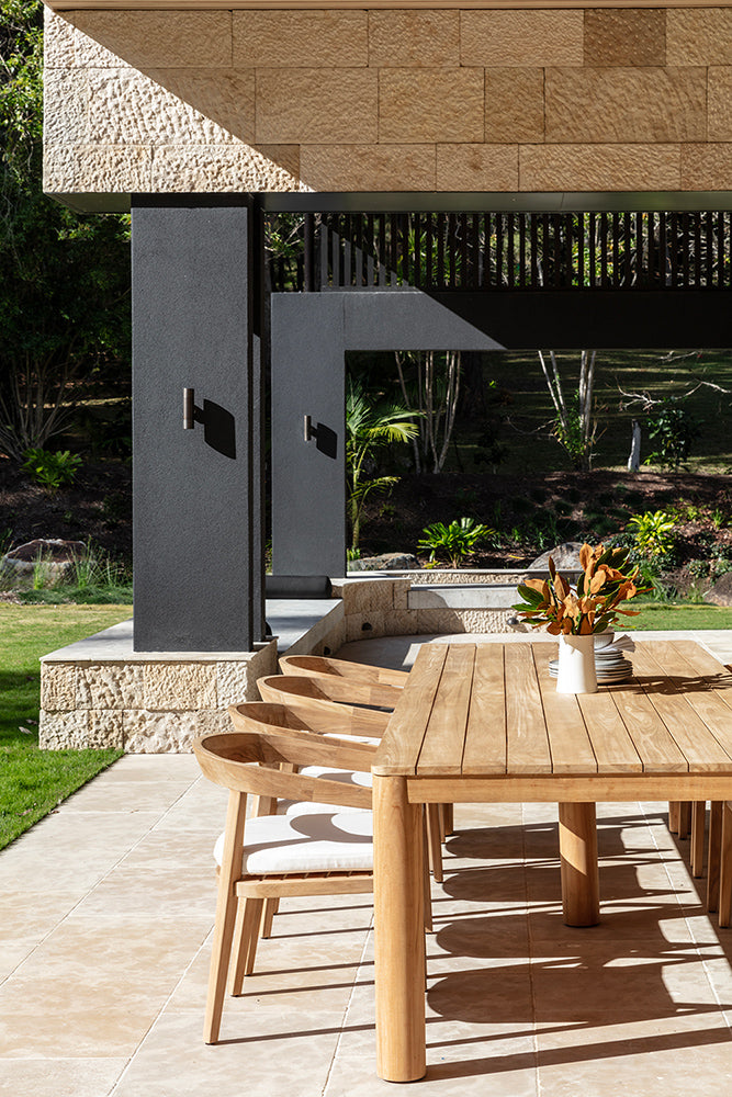 Noosa teak outdoor dining table and timber chairs viewed along a sheltered alfresco area