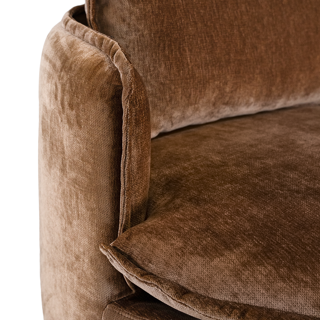 Close-up of the refined bronze fabric upholstery and cushion detailing on the Sabora Swivel Chair.