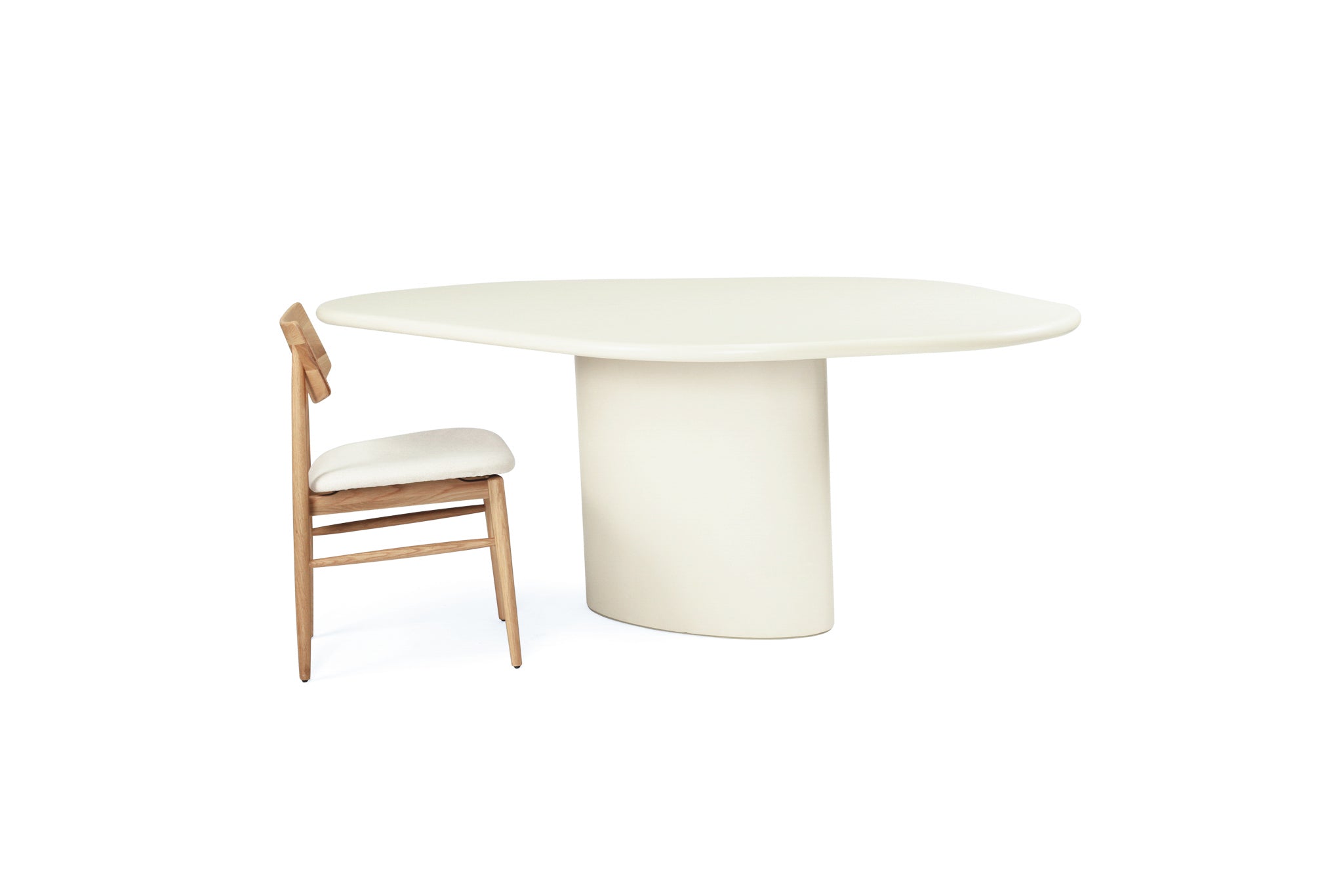 Saint Tropez Dining Table with ivory micro cement finish – modern coastal design with organic shape and refined matte texture - overall perspective 2
