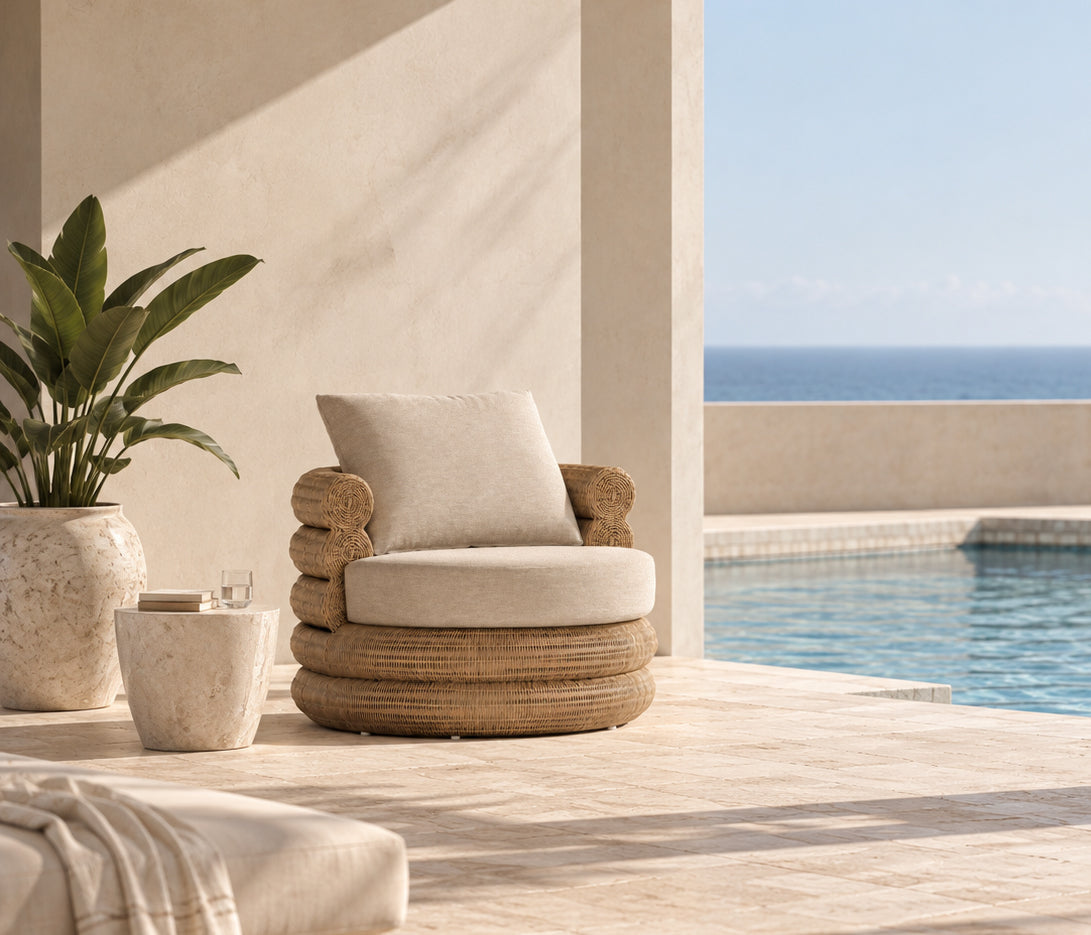 Satori outdoor swivel chair with neutral cushions styled on a terrace beside a swimming pool