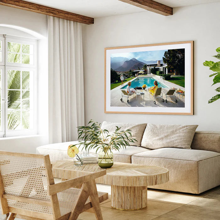 Slim Aarons Poolside Gossip photographic print, iconic Palm Springs 1970 image featuring Lita Baron, Nelda Linsk, and Helen Dzo Dzo, premium artwork with mat board and white self-border.