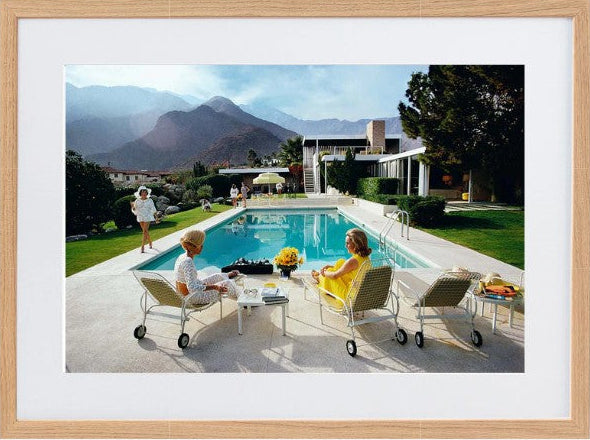 Slim Aarons Poolside Gossip photographic print, iconic Palm Springs 1970 image featuring Lita Baron, Nelda Linsk, and Helen Dzo Dzo, premium artwork with mat board and white self-border. Scandi Frame.