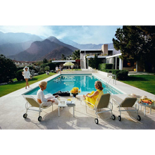 Load image into Gallery viewer, Slim Aarons Poolside Gossip photographic print, iconic Palm Springs 1970 image featuring Lita Baron, Nelda Linsk, and Helen Dzo Dzo, premium artwork. Unframed.