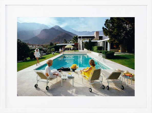 Slim Aarons Poolside Gossip photographic print, iconic Palm Springs 1970 image featuring Lita Baron, Nelda Linsk, and Helen Dzo Dzo, premium artwork with mat board and white self-border. White Frame.