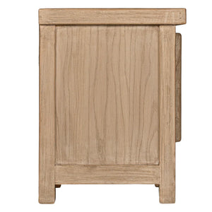 Bulu Bedside Table with left-hand door, handcrafted from reclaimed timber with natural weathered texture and carved details, coastal organic furniture with timeless character. Side perspective.