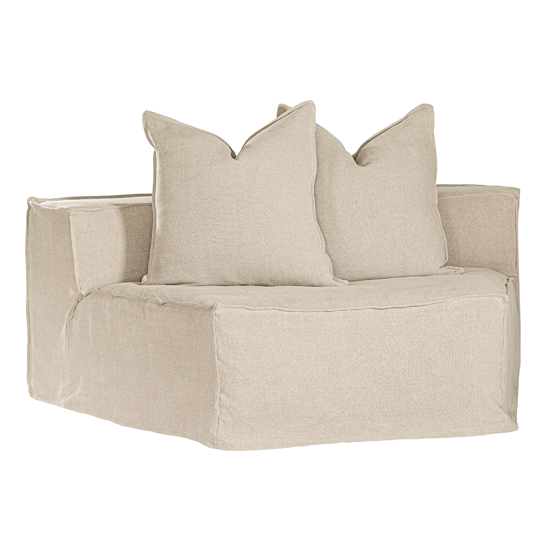 Hendrix Modular Sofa Curve Module in Sand, front three-quarter view with two scatter cushions