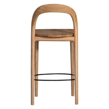 Load image into Gallery viewer, Loki Bar Chair in solid oak with natural finish, featuring sculptural minimalist design, rich wood grain, and black iron footrest for a modern touch. Back perspective.