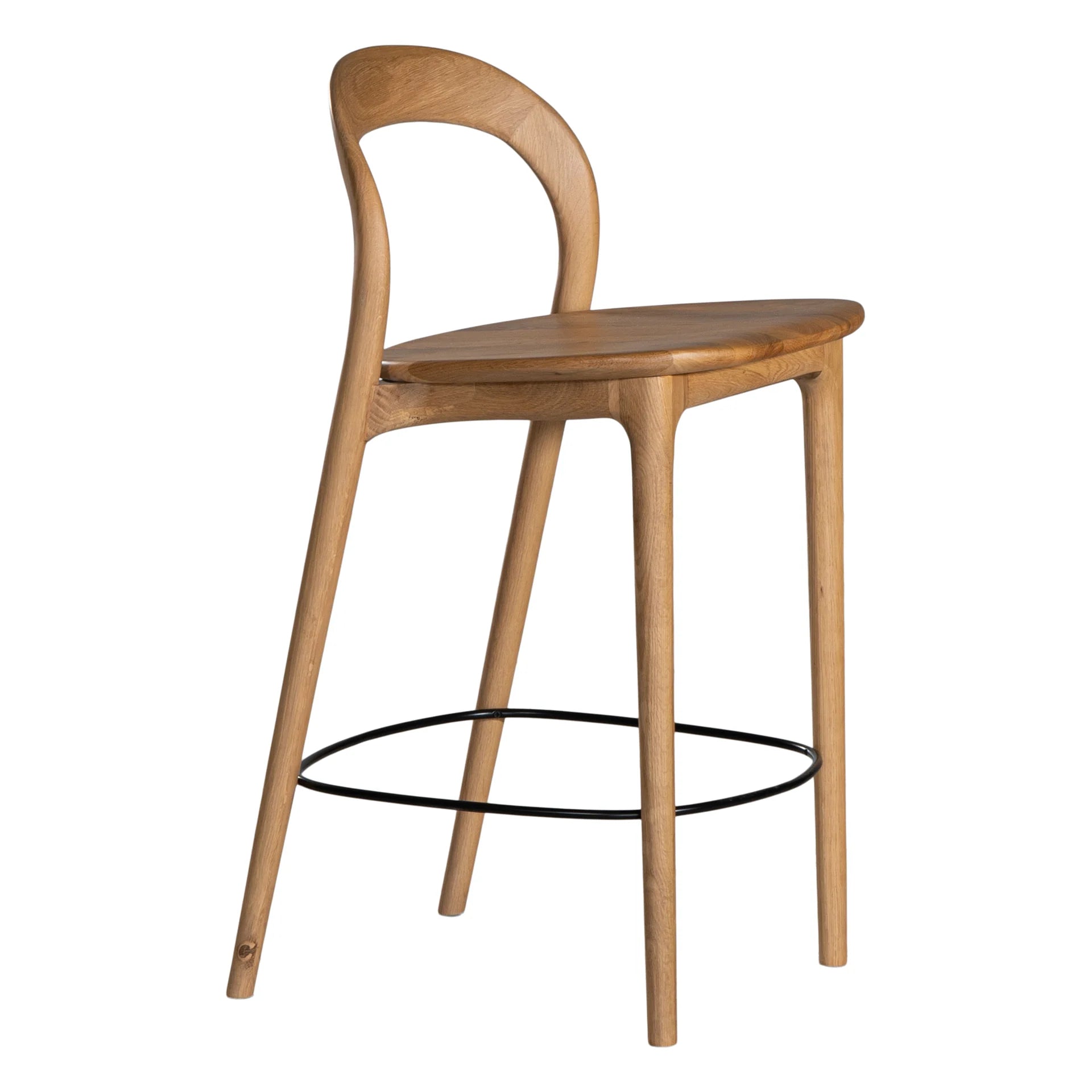 Loki Bar Chair in solid oak with natural finish, featuring sculptural minimalist design, rich wood grain, and black iron footrest for a modern touch. Side angle perspective.