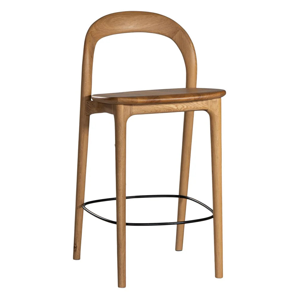 Loki Bar Chair in solid oak with natural finish, featuring sculptural minimalist design, rich wood grain, and black iron footrest for a modern touch.