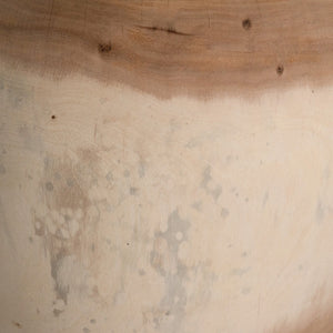 Rundu Table Lamp handcrafted from solid munggur wood with hand-carved textured grooves, showcasing natural wood variations and a soft ambient glow. Close up base.