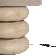 Load image into Gallery viewer, Rundu Table Lamp handcrafted from solid munggur wood with hand-carved textured grooves, showcasing natural wood variations and a soft ambient glow. Close up with cable.