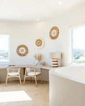 Load image into Gallery viewer, Rundu Table Lamp handcrafted from solid munggur wood with hand-carved textured grooves, showcasing natural wood variations and a soft ambient glow.  Styled beautifully in this coastal home.