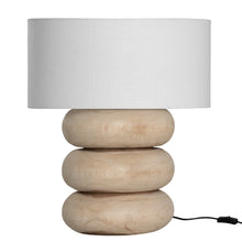 Load image into Gallery viewer, Rundu Table Lamp handcrafted from solid munggur wood with hand-carved textured grooves, showcasing natural wood variations and a soft ambient glow. Natural base with white shade.