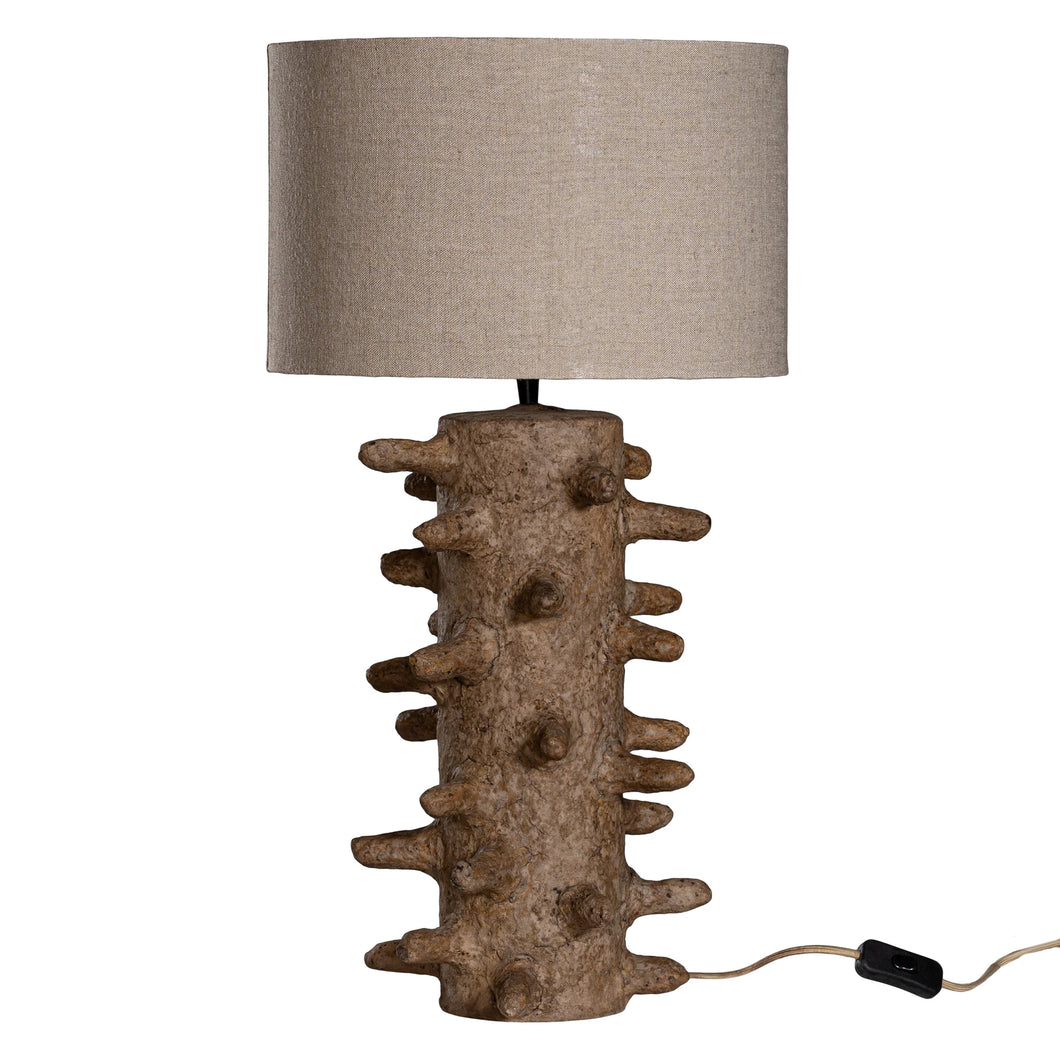 Sula Table Lamp handcrafted from eco-friendly papier-mâché with an organic spike design, casting a soft ambient glow and unique shadow play.