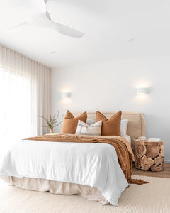 Hendrix Bedhead with feather cushioning and removable linen slipcover, timber frame upholstered bedhead for modern coastal bedroom style.  Beautifully styled in this modern coastal bedroom interior with Nahoon side table.