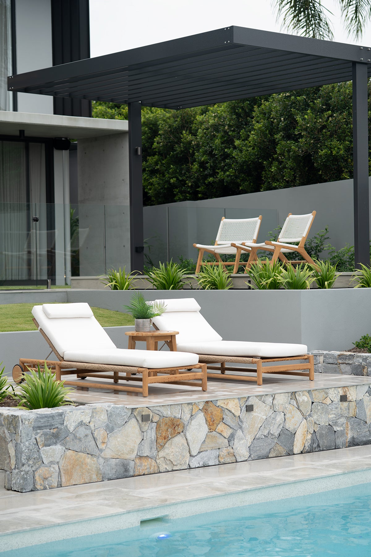 Vaucluse Outdoor Sunlounger in Grade A teak with white Sunbrella cushion, adjustable backrest and wheels, durable coastal outdoor furniture for poolside or garden relaxation.  Resort style living.
