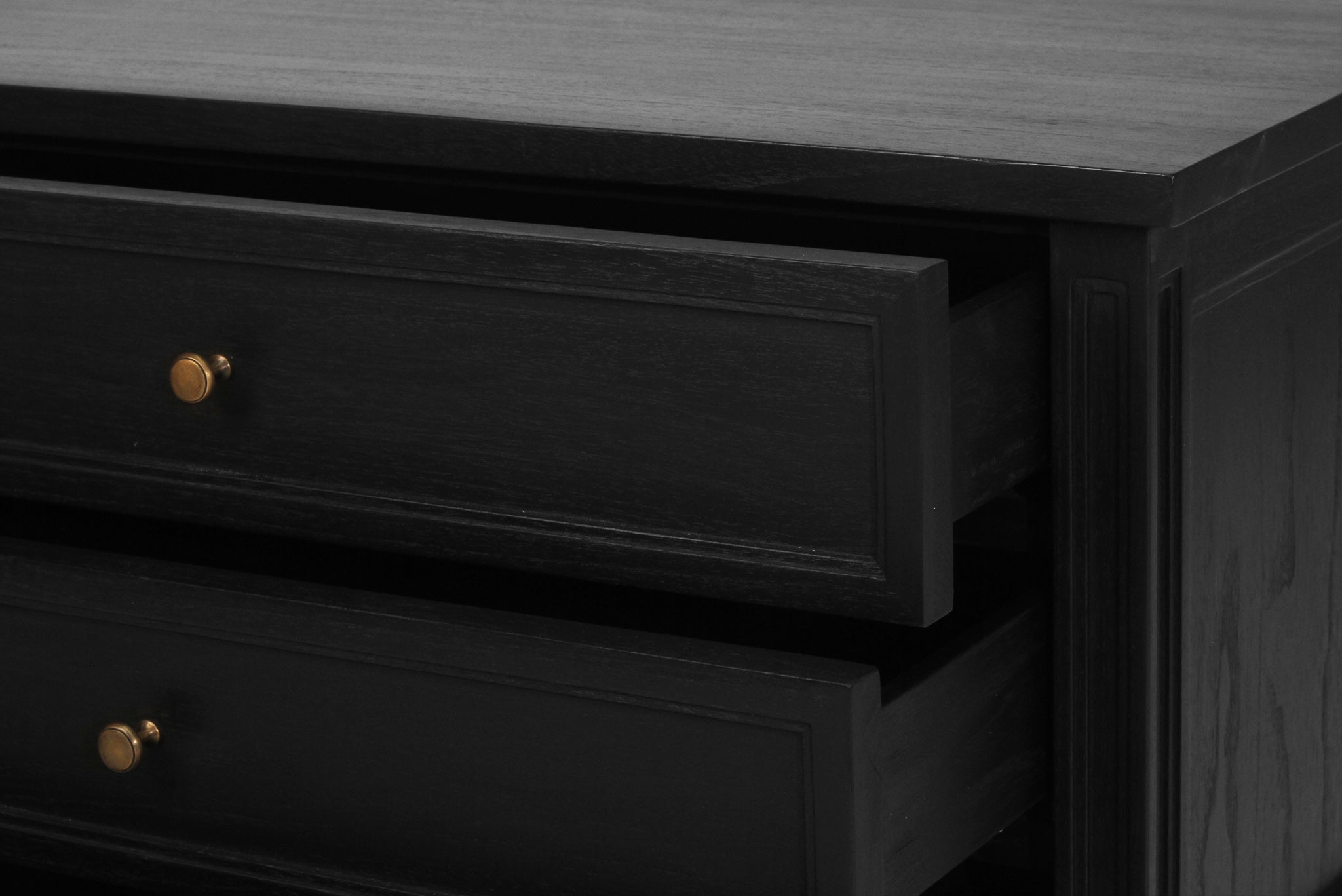 Whitsunday Wide Nightstand in black, solid hardwood bedside table with three drawers, coastal bedroom furniture with timeless beachside charm. Drawer close up.