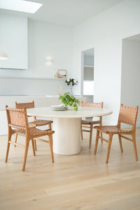 Dining chair with natural woven leather straps and sleek modern design, crafted for style and comfort. Styled perfectly in this modern coastal home.  Magnolia Lane 1