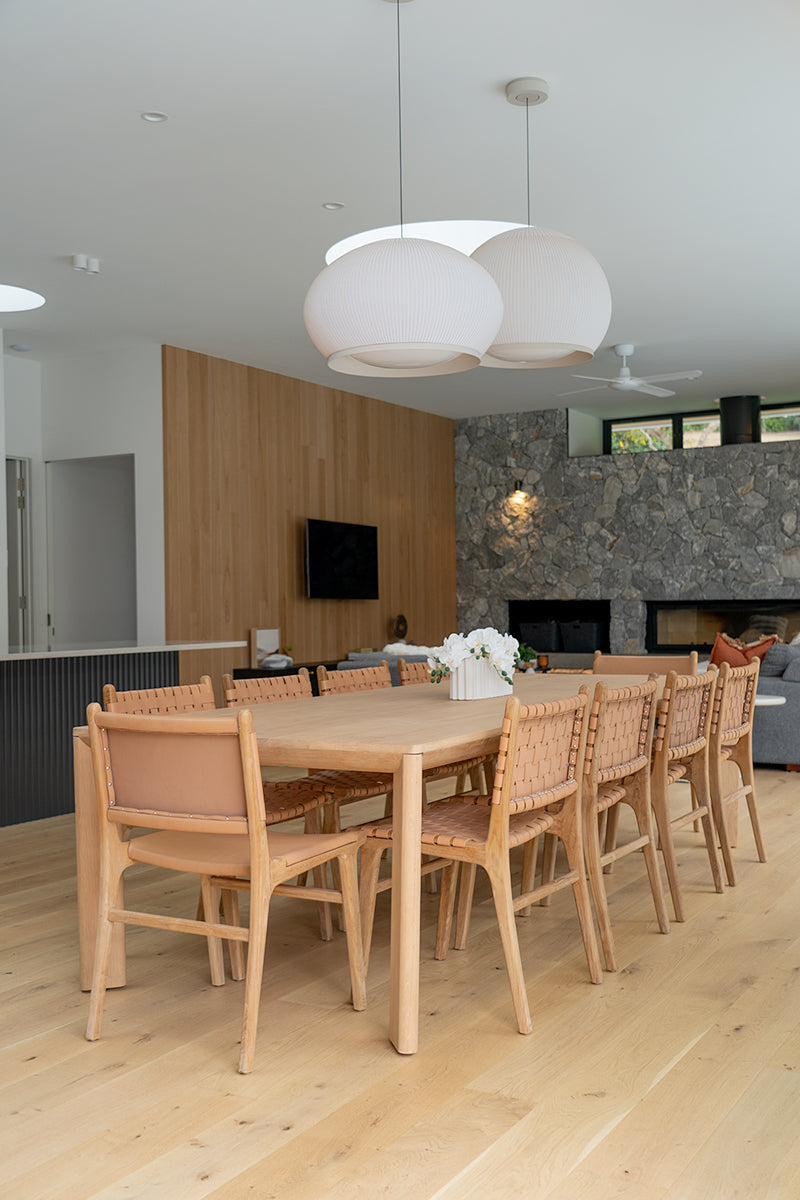 Dining chair with natural woven leather straps and sleek modern design, crafted for style and comfort. Styled perfectly in this modern coastal home.  Magnolia Lane 2