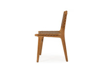 Load image into Gallery viewer, Dining chair with woven leather straps and sleek modern design, crafted for style and comfort. Side perspective. Magnolia Lane.