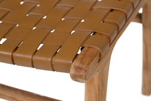 Load image into Gallery viewer, Dining chair with woven leather straps and sleek modern design, crafted for style and comfort. Seat perspective. Magnolia Lane