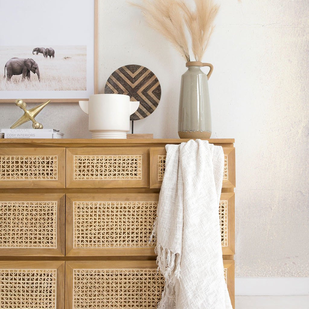 Five Drawer Rattan Chest of Drawers crafted from sustainable teak with finely sanded finish – durable and stylish storage for modern bedrooms.  Styled beautifully in this modern coastal bedroom.