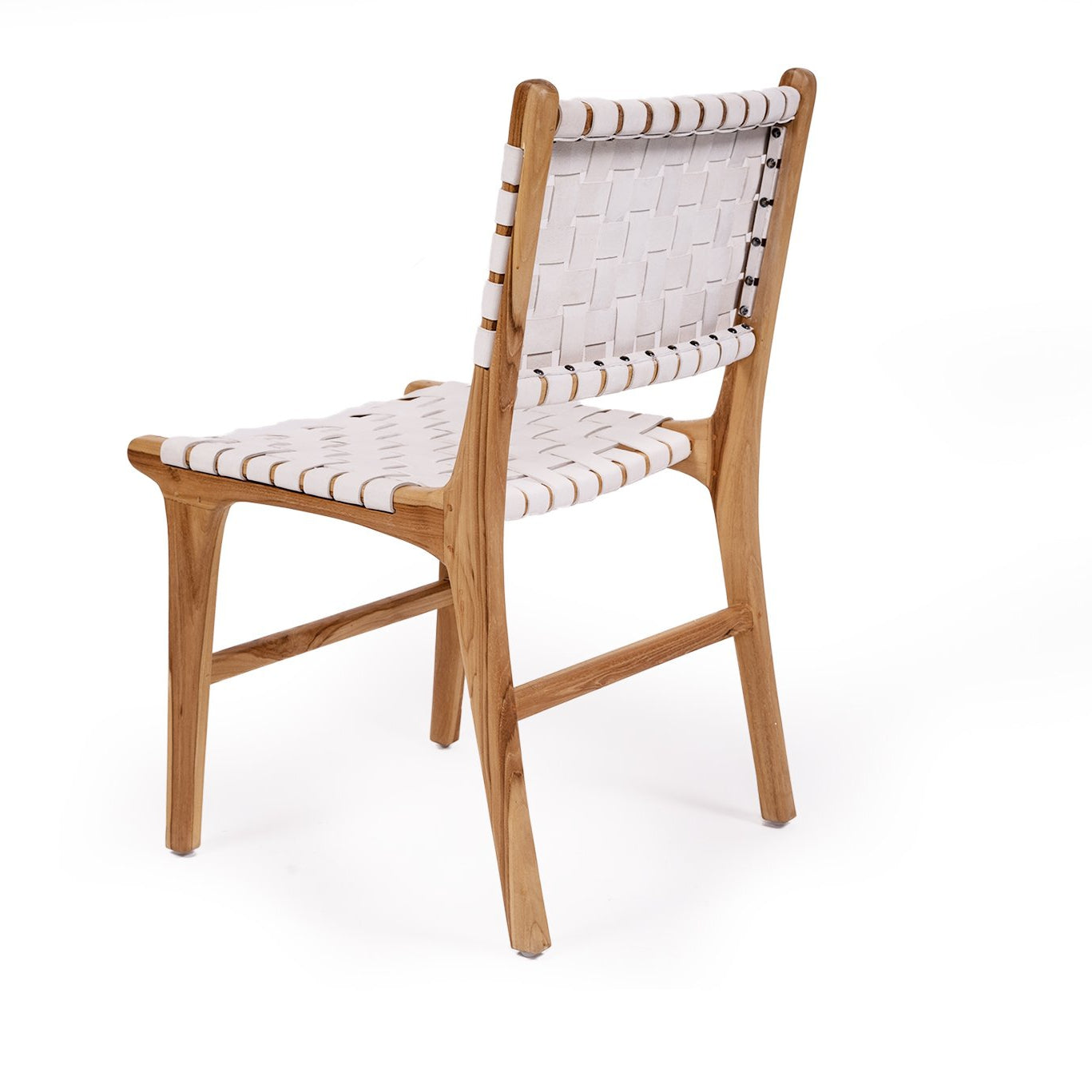 Dining chair with white woven leather straps and sleek modern design, crafted for style and comfort. Back angle perspective.  Magnolia Lane