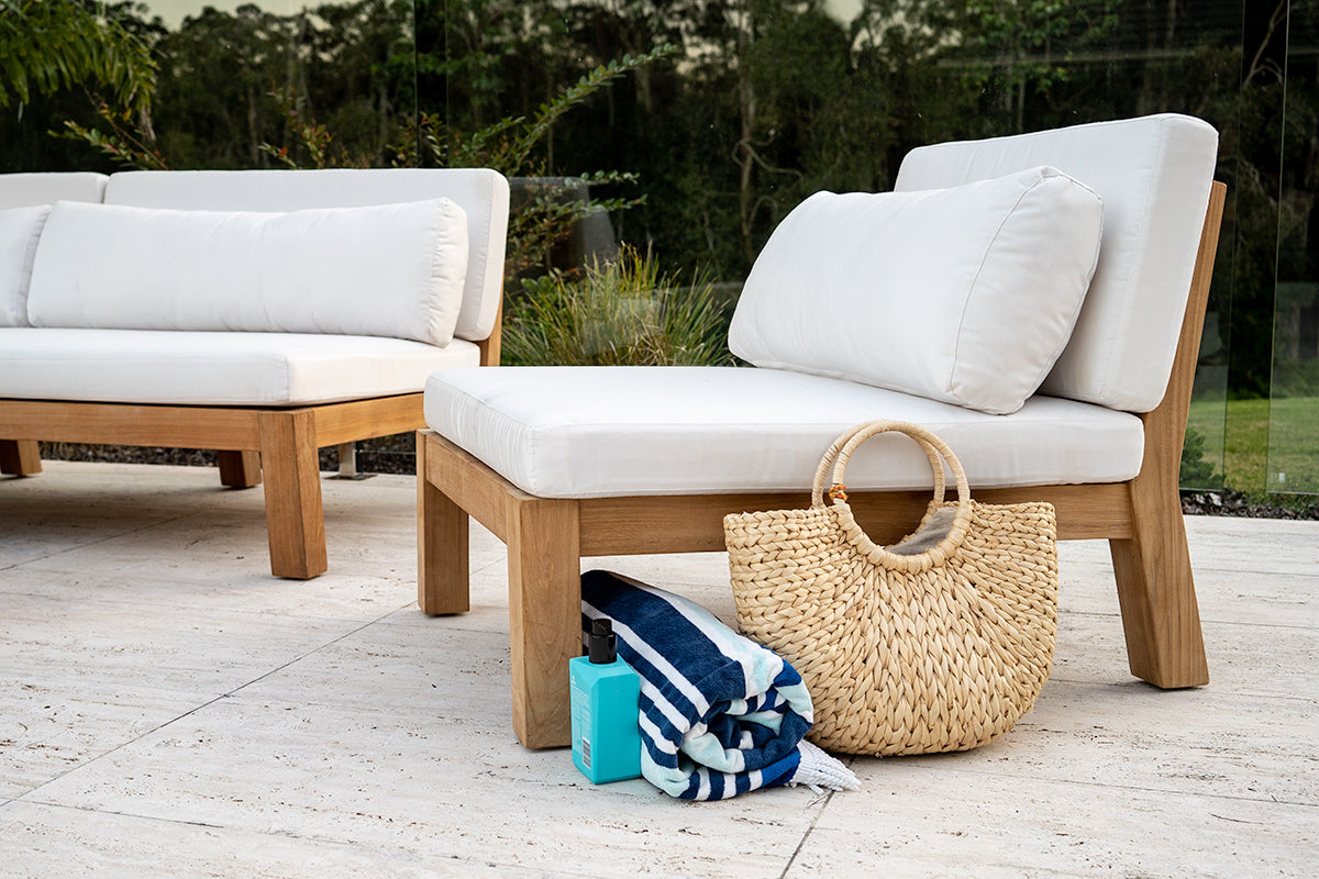 Bedarra teak outdoor armless single seater, garden patio setting with the single seater, matching sofa, woven bag and towels