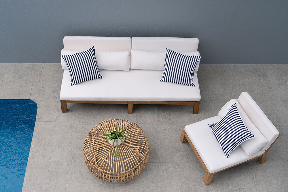 Bedarra teak outdoor armless single seater, overhead poolside setting with the single seater, matching sofa and woven coffee table